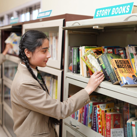 Student choosing book - JSS Public School, Ooty